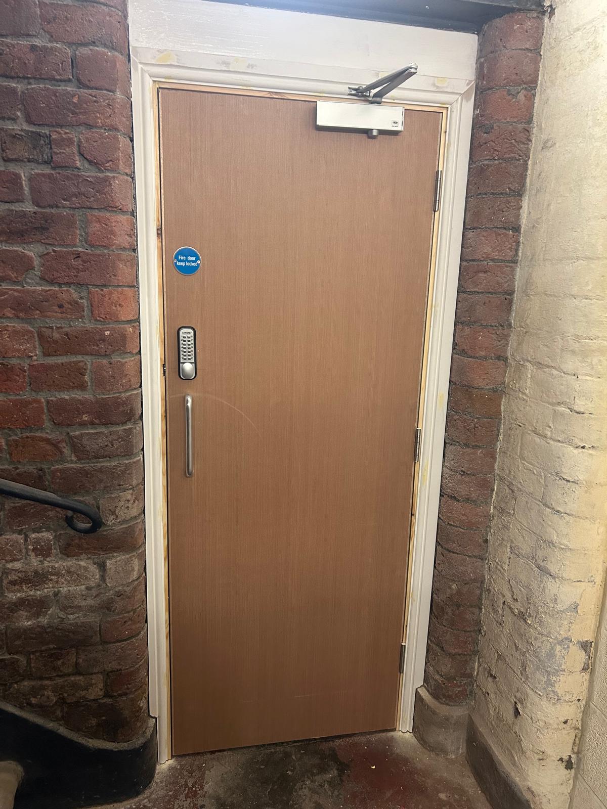 Certified fire door fitted to electric meter cupboard in a Liverpool communal area by D2 Joinery